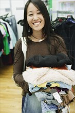 Young woman smiling for the camera while shopping