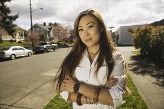 Portrait of Asian woman on residential street