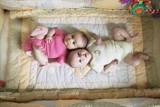 High angle view of two babies on blanket