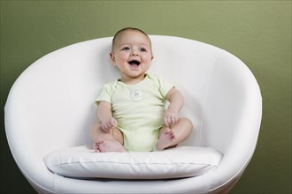 Laughing baby in chair