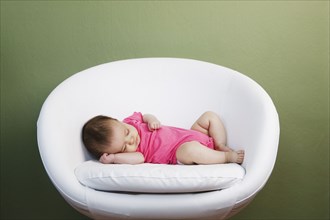 Baby sleeping on chair