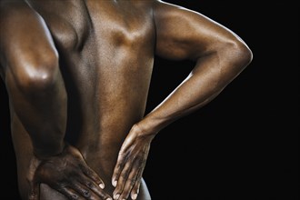 African man with hands on bare back