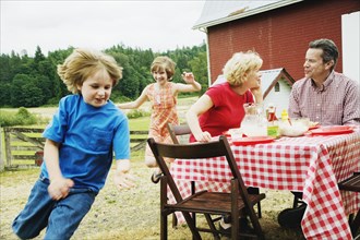 Family eating outdoors on farm