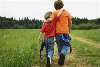 Two brothers walking in field