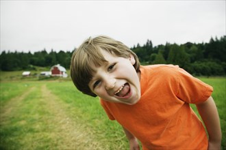 Boy laughing in farm field