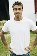Man with hands on hips on farm