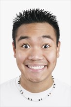 Close up of Asian man smiling with eyebrows raised
