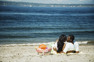 African couple kissing on beach