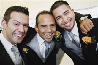 Multi-ethnic men wearing tuxedos