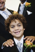 Hispanic boy wearing tuxedo