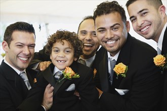 Multi-ethnic men and boy wearing tuxedos
