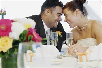 Multi-ethnic bride and groom smiling at each other