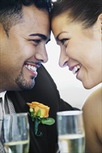 Multi-ethnic bride and groom smiling at each other