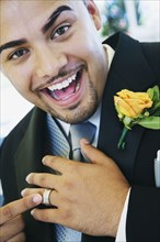 Hispanic groom showing ring