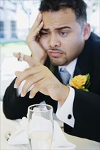 Hispanic groom looking sad