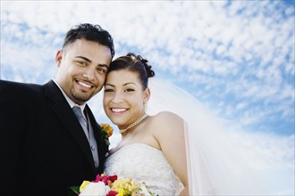 Portrait of multi-ethnic bride and groom
