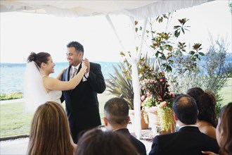 Multi-ethnic bride and groom dancing