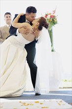 Multi-ethnic bride and groom kissing