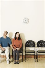 Multi-ethnic couple sitting in waiting area