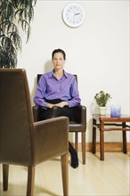 Mixed Race businesswoman sitting in waiting area