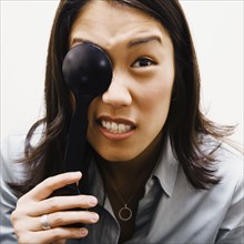 Asian woman covering eye