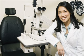 Asian female optometrist in office