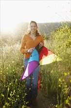 Hispanic woman holding kite outdoors