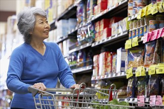 Senior Asian woman shopping in grocery store