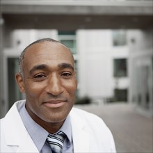 Mixed race doctor standing outdoors