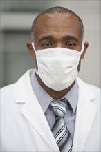 Mixed race doctor wearing surgical mask