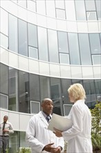 Doctors talking in hospital courtyard