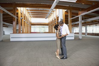 Couple dancing in empty office space