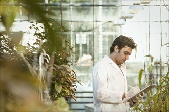 Middle Eastern scientist working in greenhouse