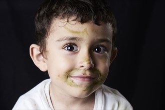 Close up of Hispanic boy with messy face