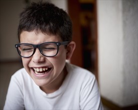 Laughing Hispanic boy wearing eyeglasses