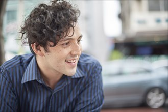 Smiling Hispanic man with curly hair