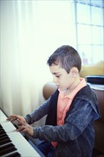 Hispanic boy playing piano