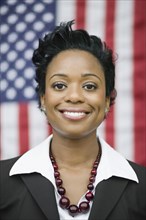 African businesswoman standing near American flag