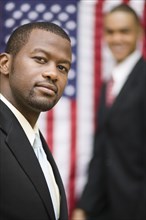 African businessmen standing near American flag