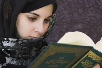 Middle Eastern teenager reading book