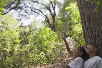 African boy and girl sitting under tree