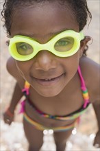 Smiling African girl wearing goggles and bikini