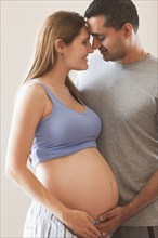 Man holding pregnant woman's stomach
