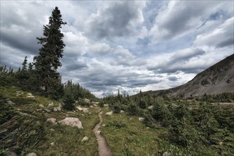 Clouds over trail in rocky landscape