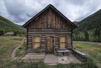 Rustic log cabin in valley