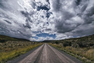 Remote dirt road under clouds