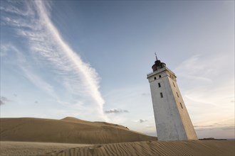 Remote tower leaning in sand dunes