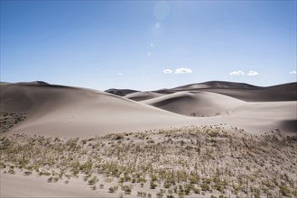 Blue sky over sand dunes
