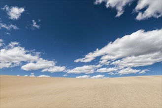 Clouds over barren desert landscape