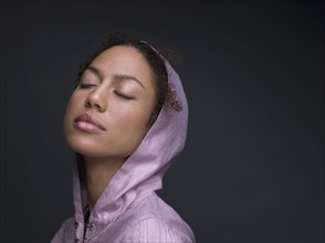 Mixed Race woman wearing hooded shirt